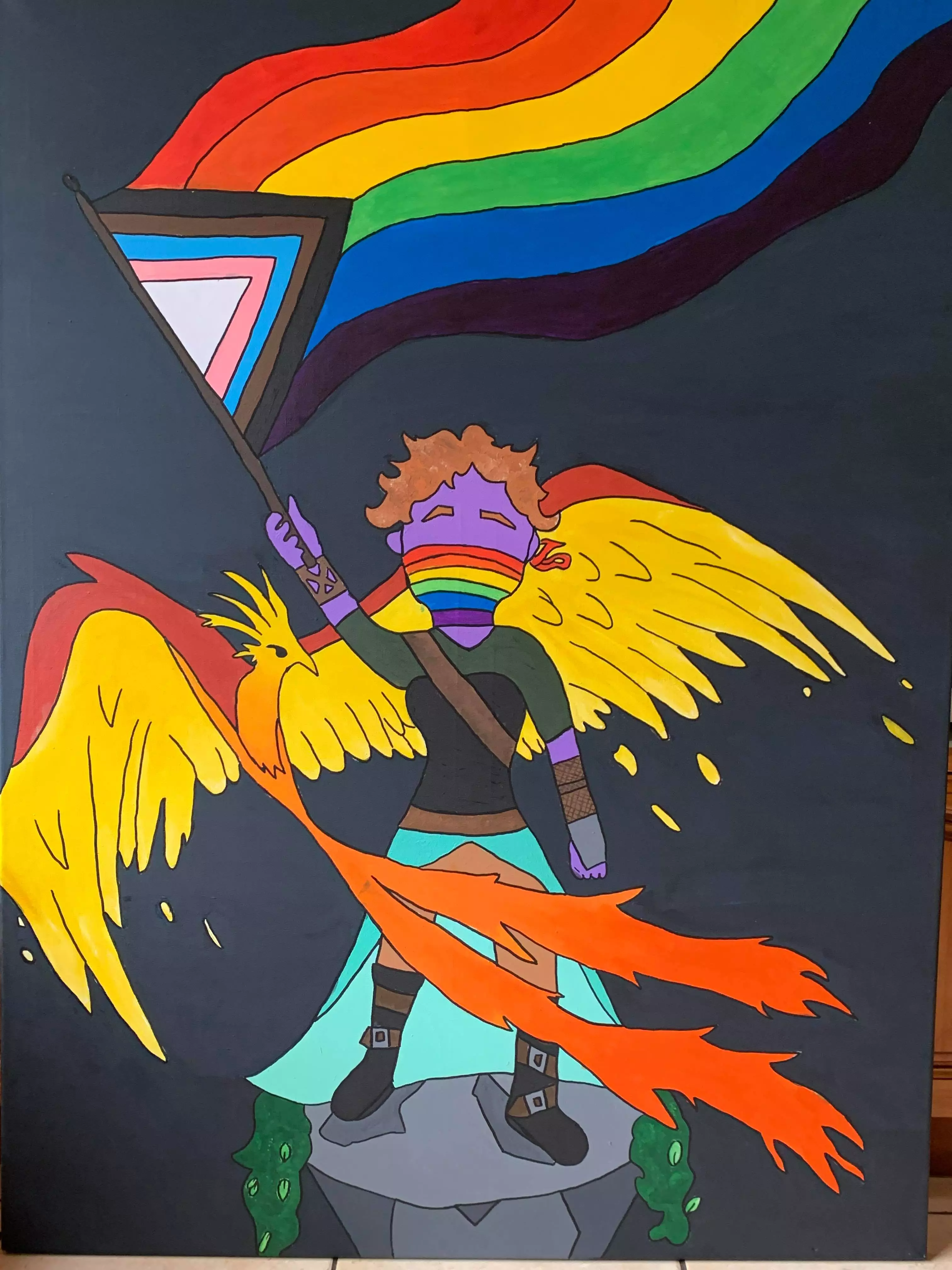 Photograph of a painting. A figure stands on a platform, their features are obscured by a rainbow mask, a flaming phoenix flies around them as they hold up a pride flag.